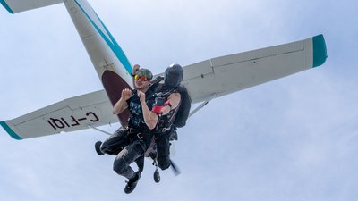 Tandem skydive exit seen from below the wing at Skydive SWOOP