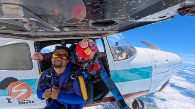 Tandem student geared up in the aircraft door at the Skydive SWOOP dropzone
