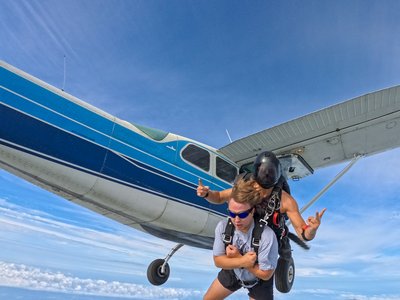 Tandem pair dropping away beneath the jump plane near Hamilton, Ontario