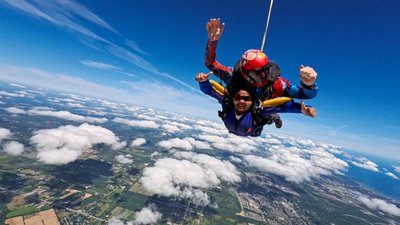 Skydiver waving in freefall over the GTA countryside