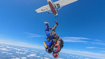 Two skydivers exiting the aircraft head-down over Dundas, Ontario